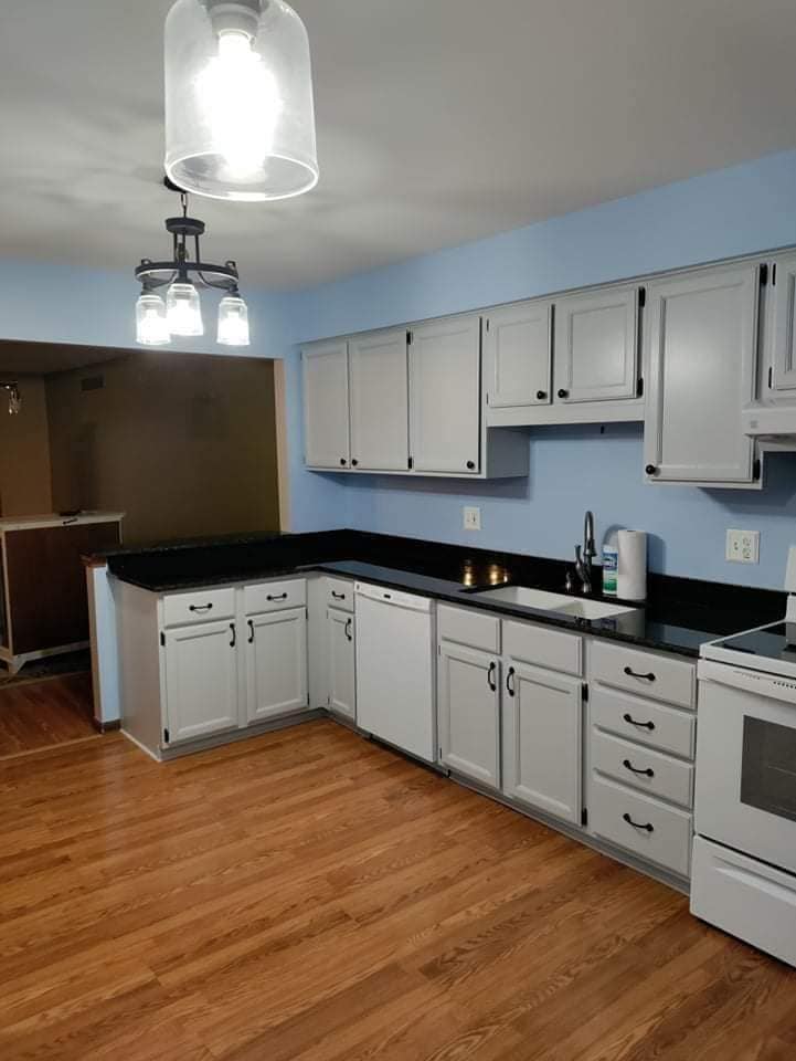 A&M Dearborn Heights kitchen with white painted cabinets and blue walls